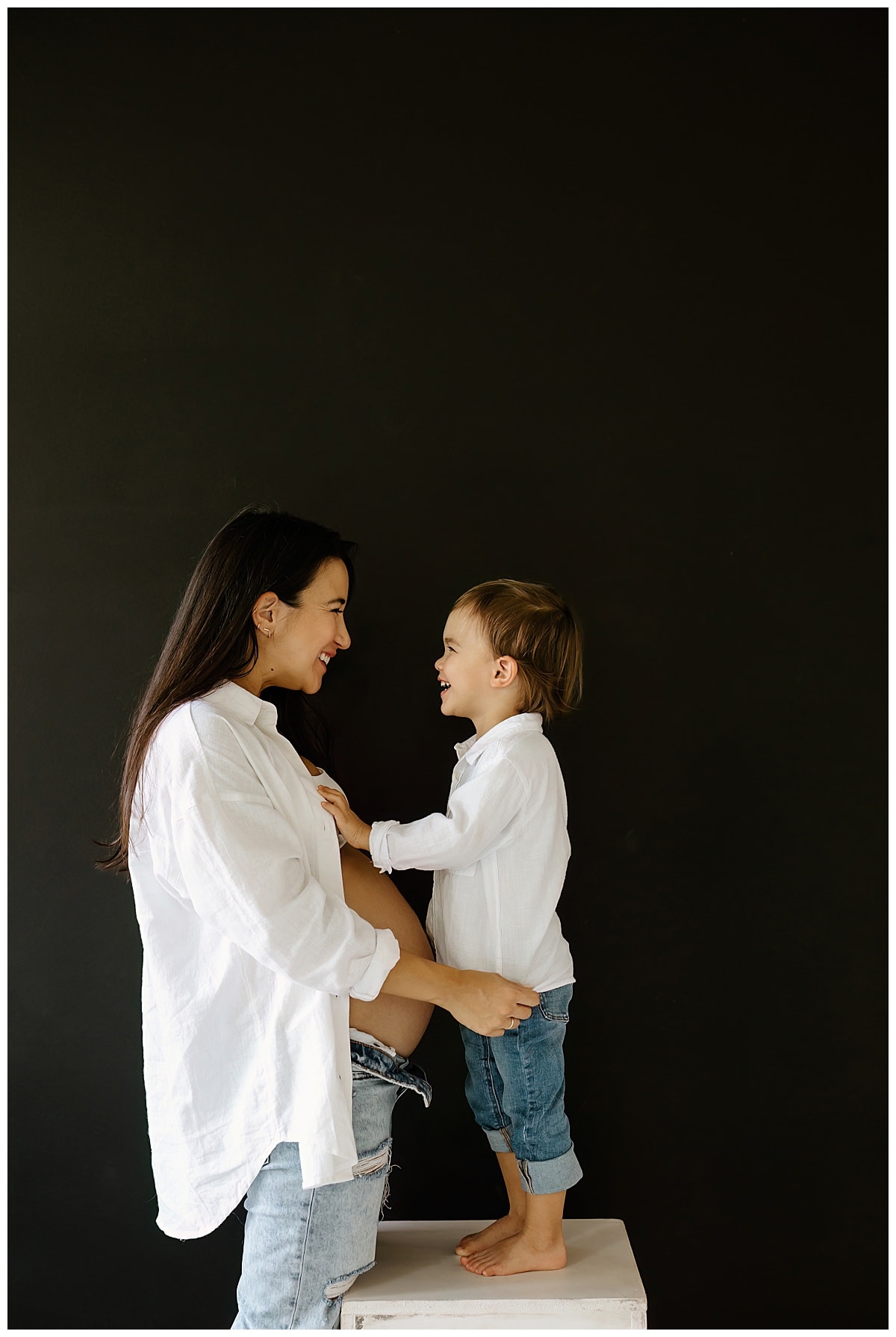 Mom and son smile at one another for Studio Maternity Photos