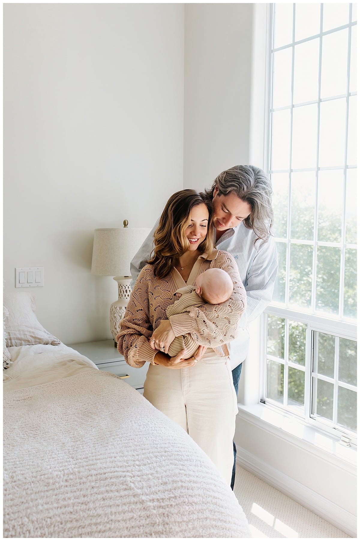 Mom and dad smile at newborn baby for Austin Motherhood Photographer