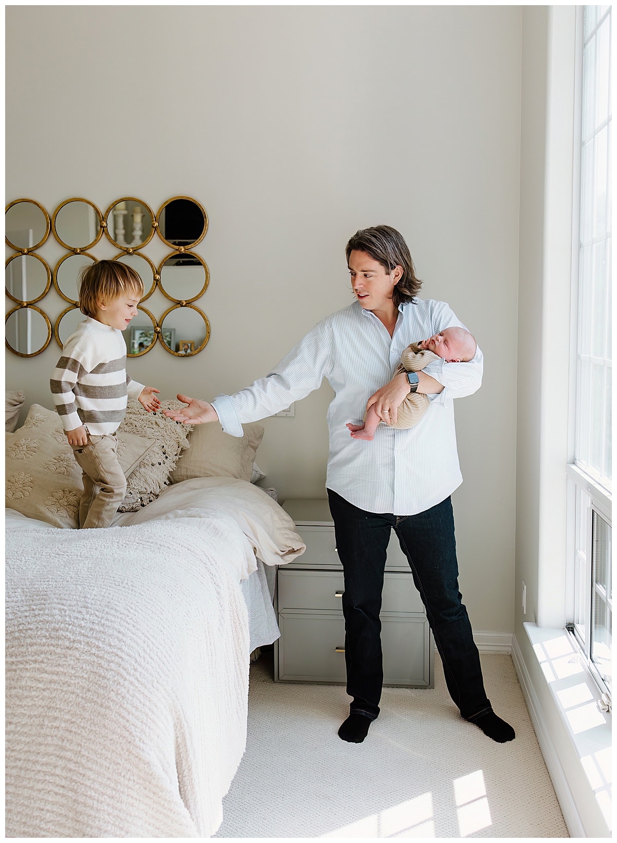 Dad holds youngest son and plays with older sibling for Austin Motherhood Photographer