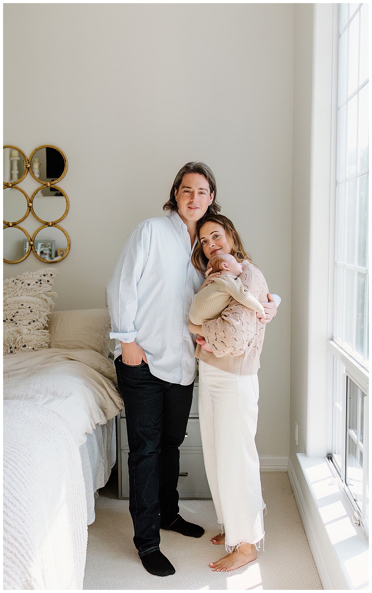 Parents hold their infant close for a successful Newborn Session With Siblings
