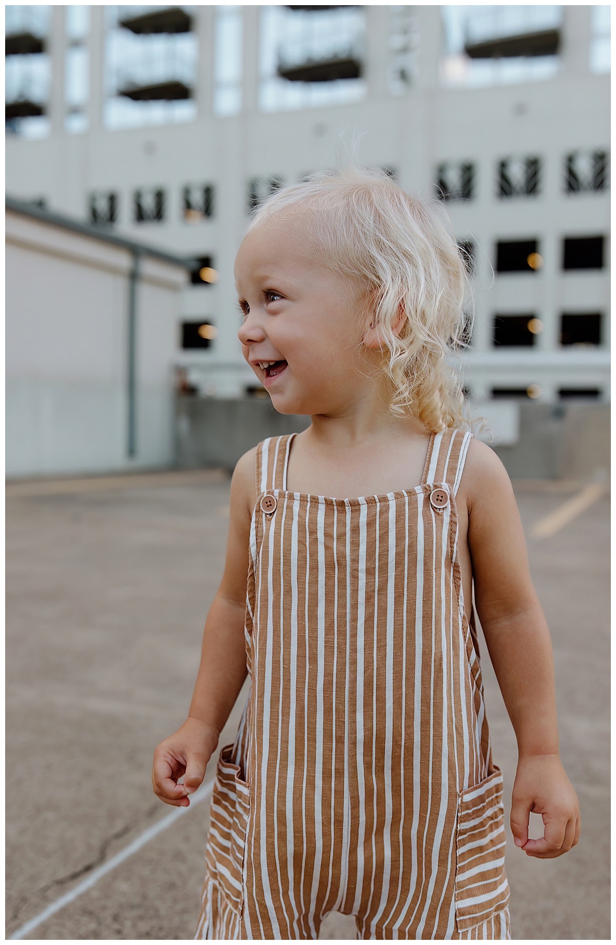 Young boy smiles big for Downtown Austin Rooftop Family Session 
