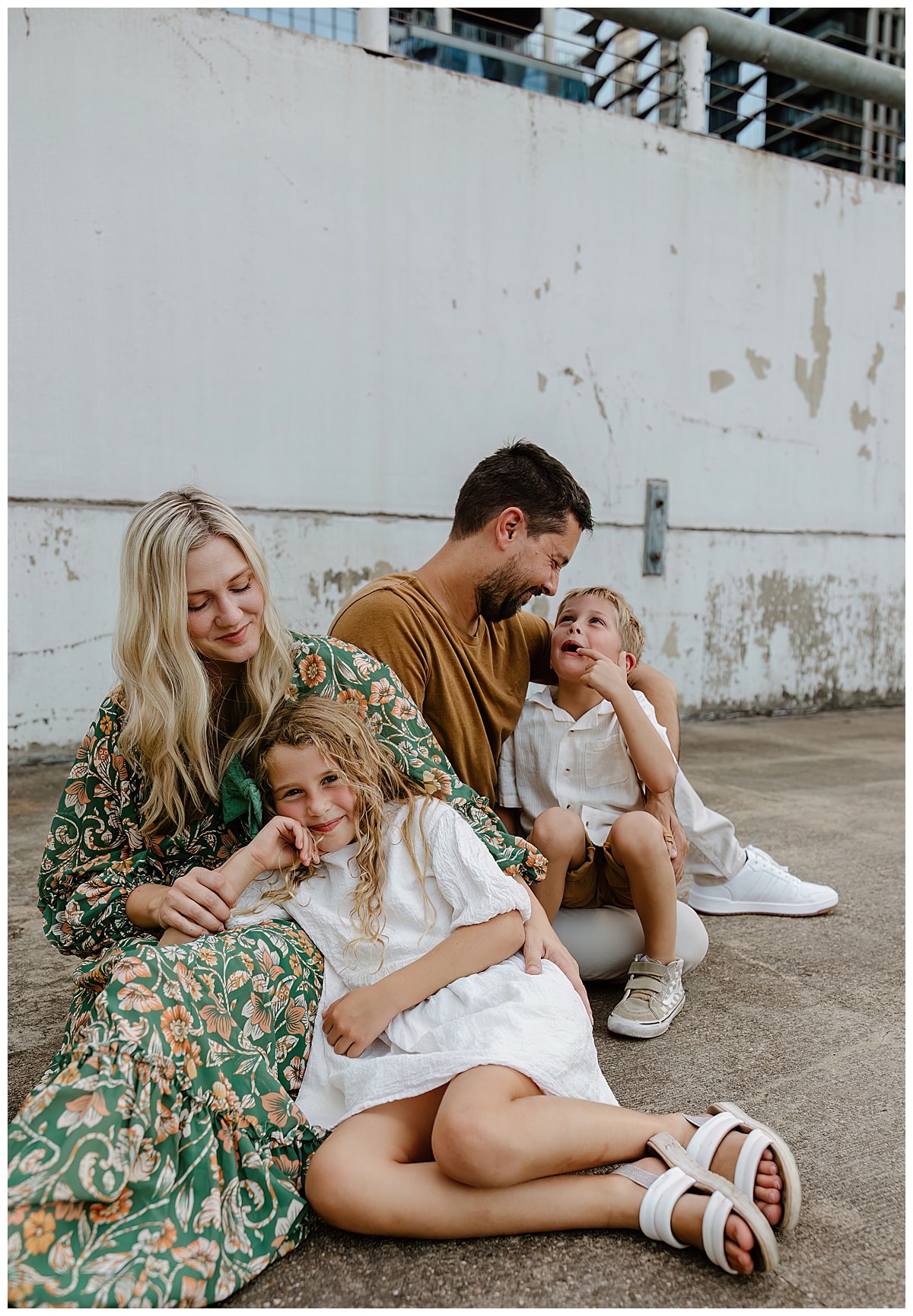Parents smile at their kids for Downtown Austin Rooftop Family Session 