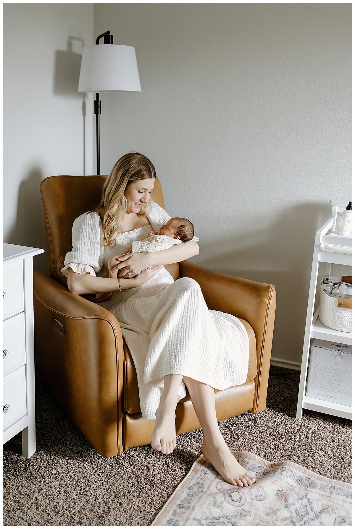 Mother smiles at baby for an In-Home Newborn Storytelling Session