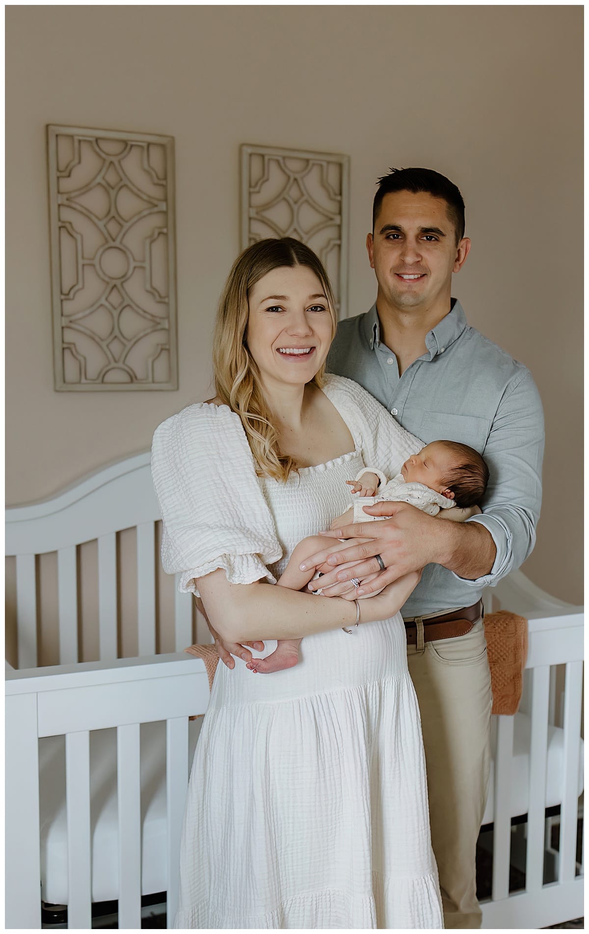 Parents hold baby for In-Home Newborn Storytelling Session