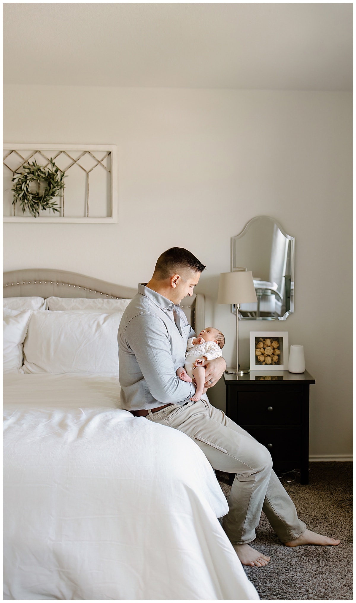 Dad smiles at baby during their In-Home Newborn Storytelling Session