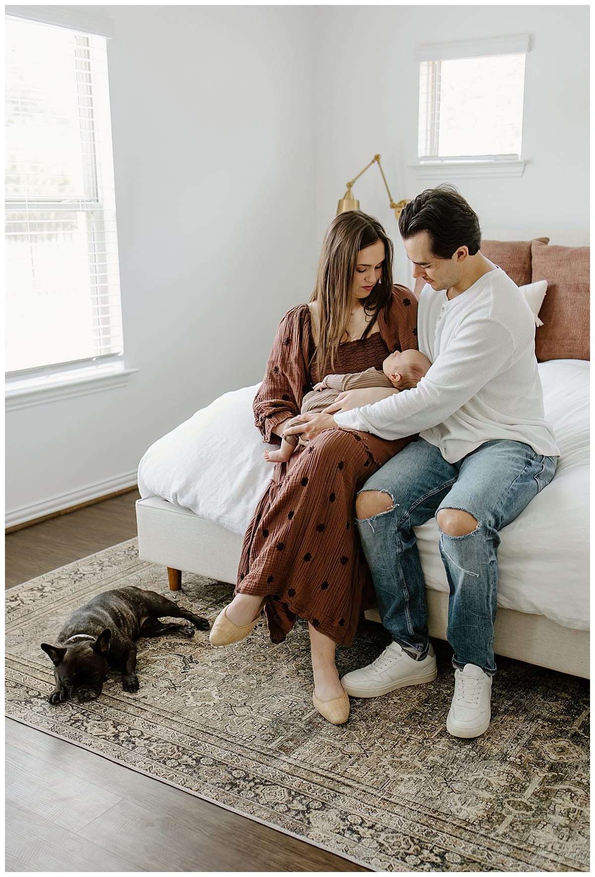 After Preparing For Your Newborn Storytelling Session mom and dad hold baby close