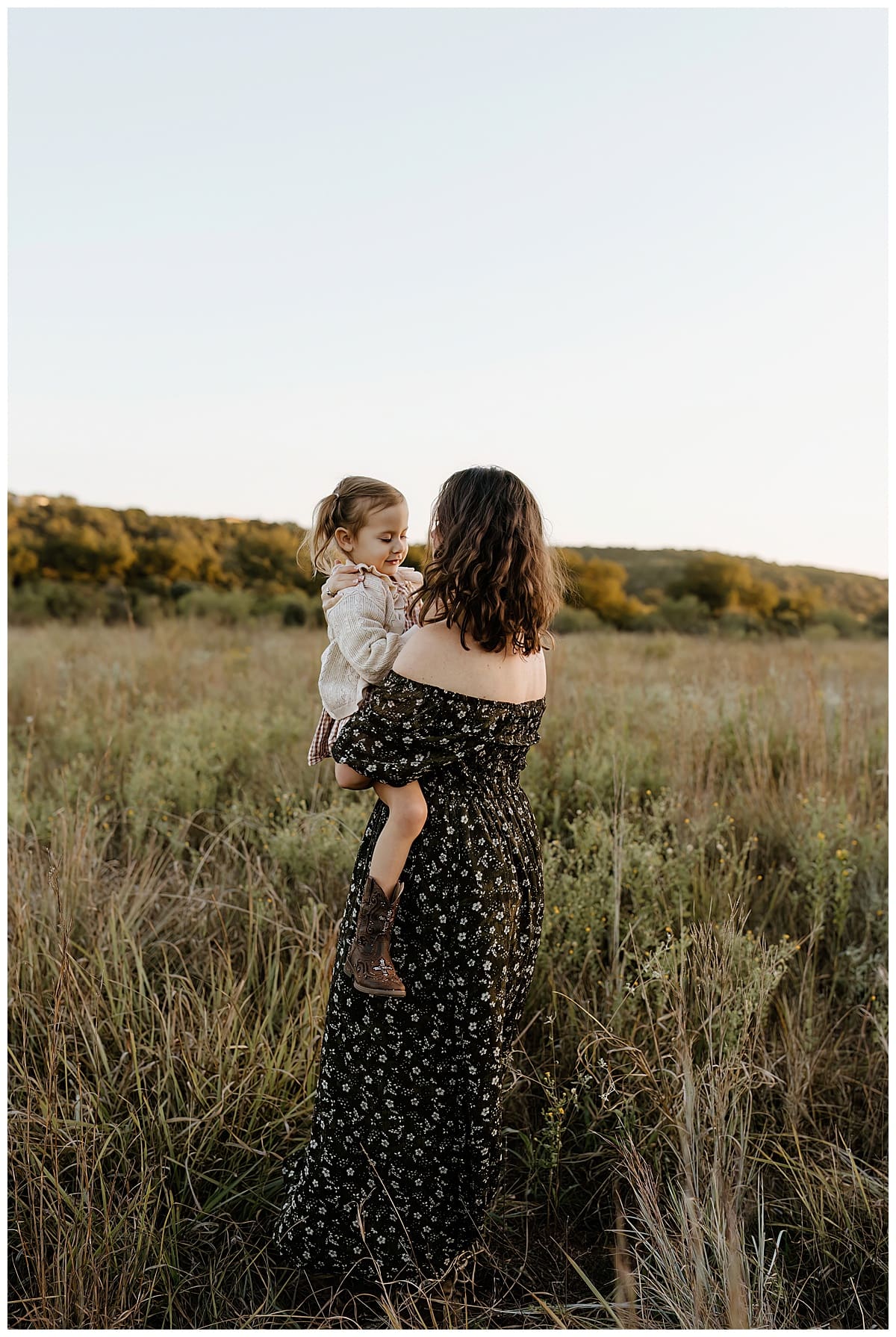 Mom and young daughter smile at each other for their Sunrise Family Photos