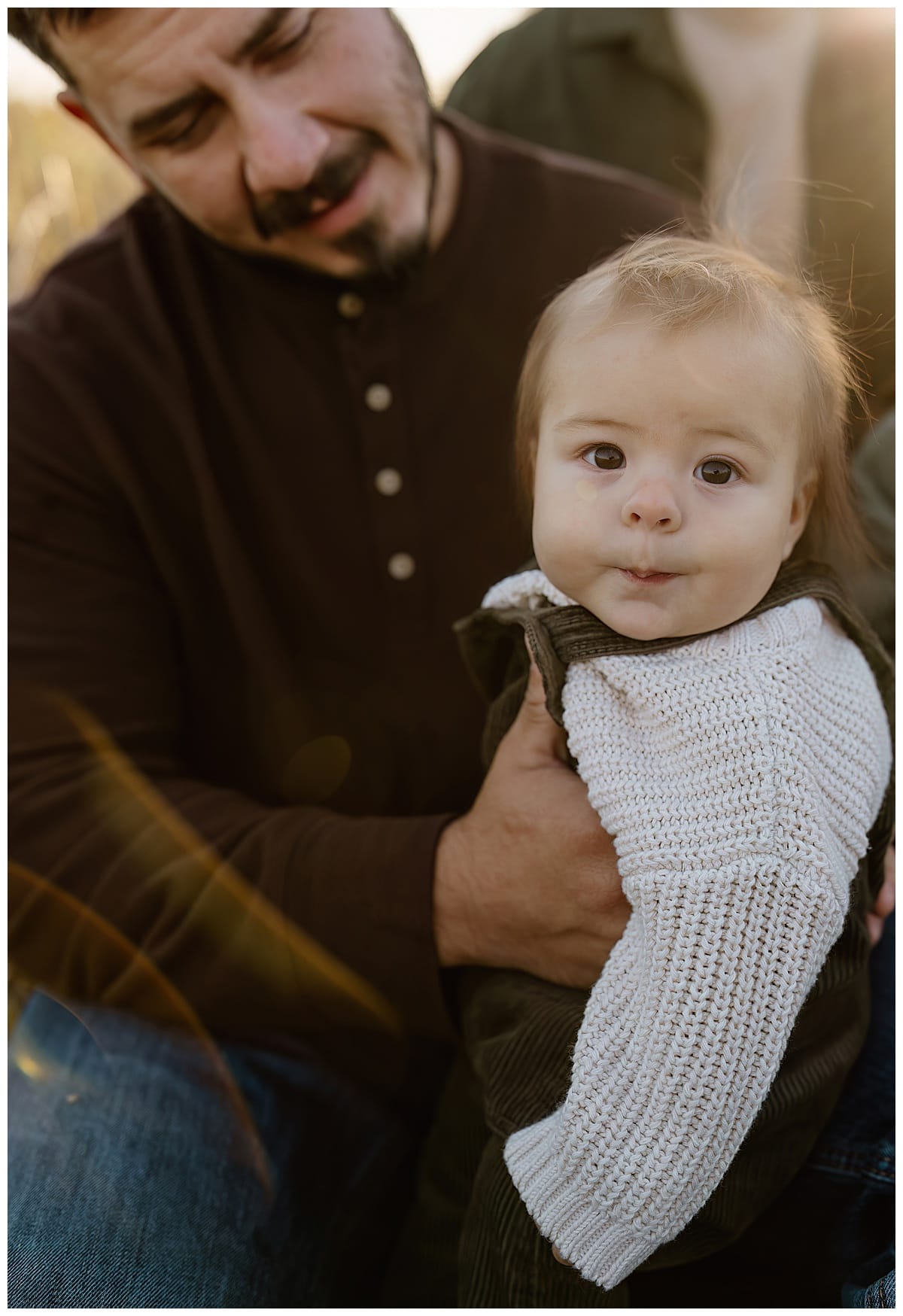 Young baby boy sits up during their Sunrise Family Photos