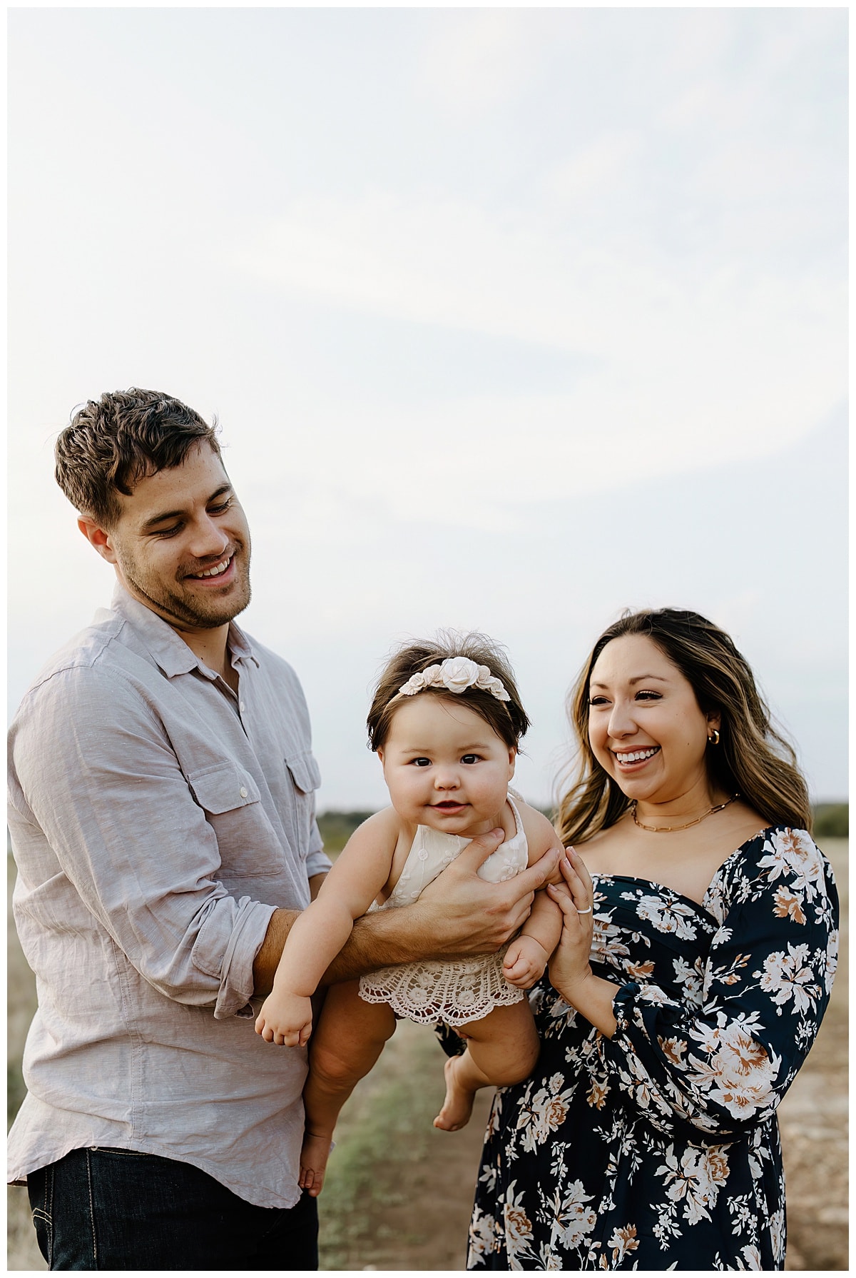 Mom and dad swing baby through the air for Our Adventuring Souls Photography
