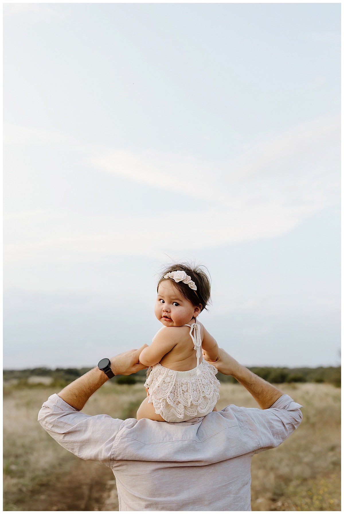 Baby rides on dads shoulders for First Birthday Family Photos 