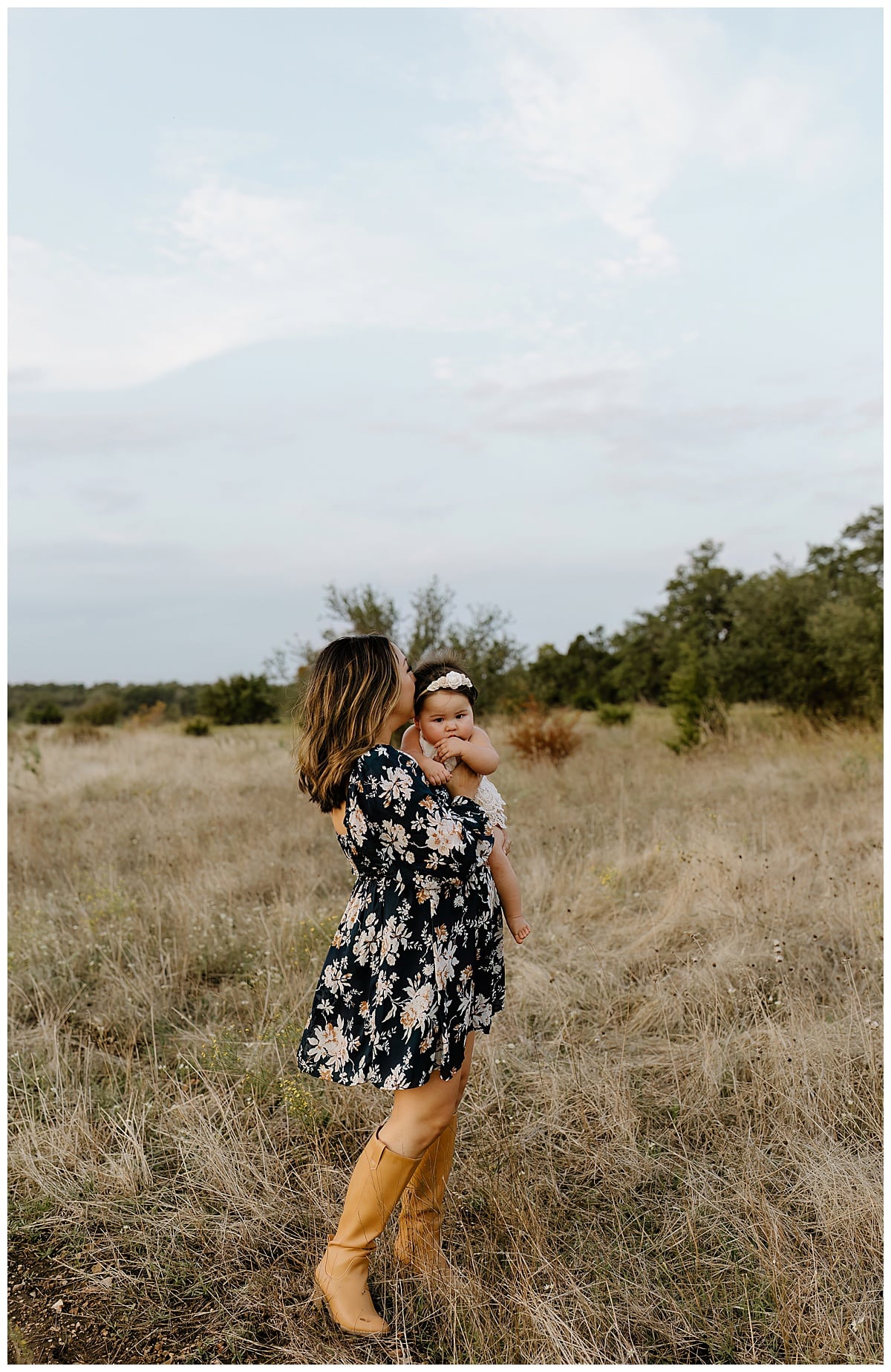 Mom and baby share a kiss for First Birthday Family Photos 