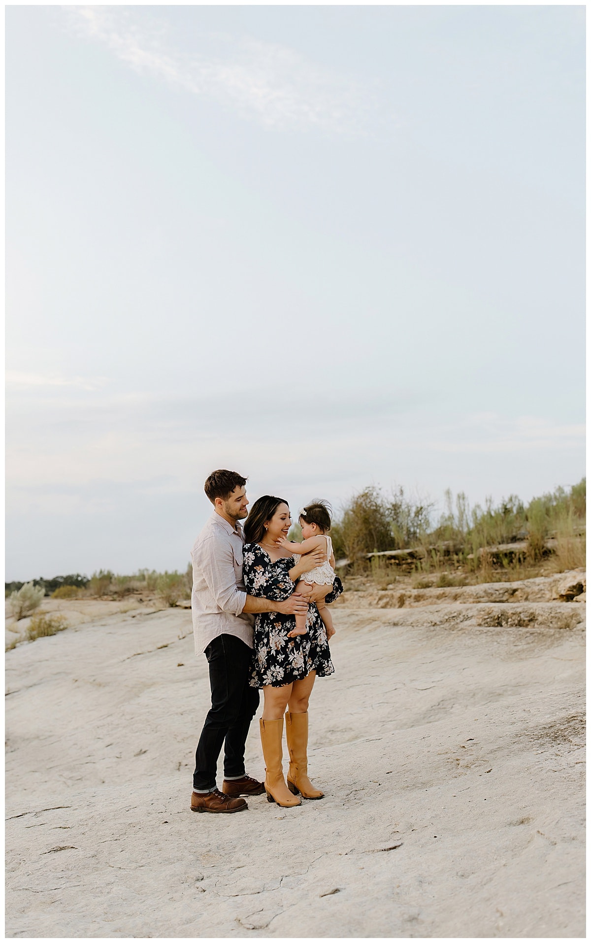 Mom and dad smile at baby girl for Austin Motherhood Photographer