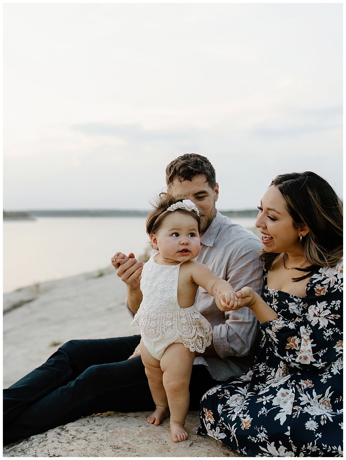 Mother and father hold baby close and smile together for Austin Motherhood Photographer