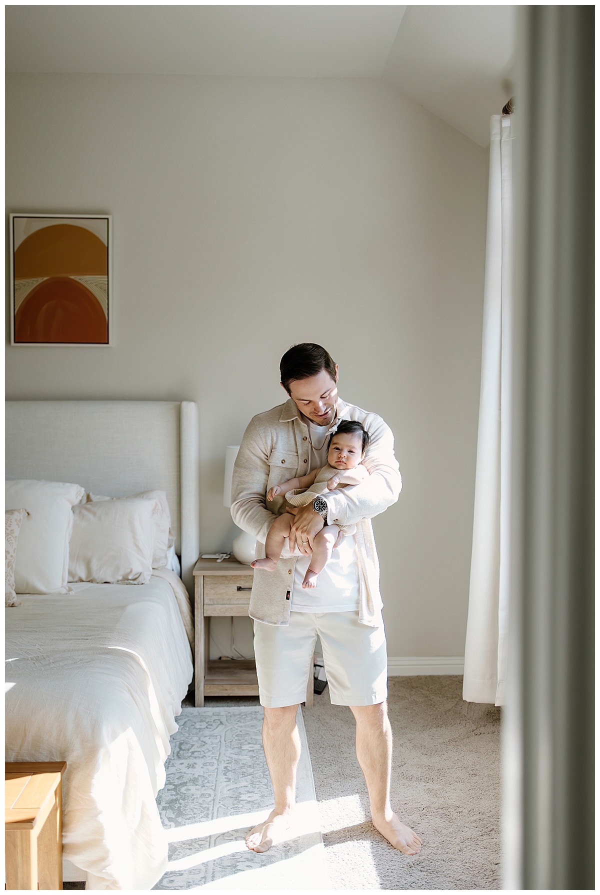 Dad holds little girl understanding the importance of being able to Document Your Newborn