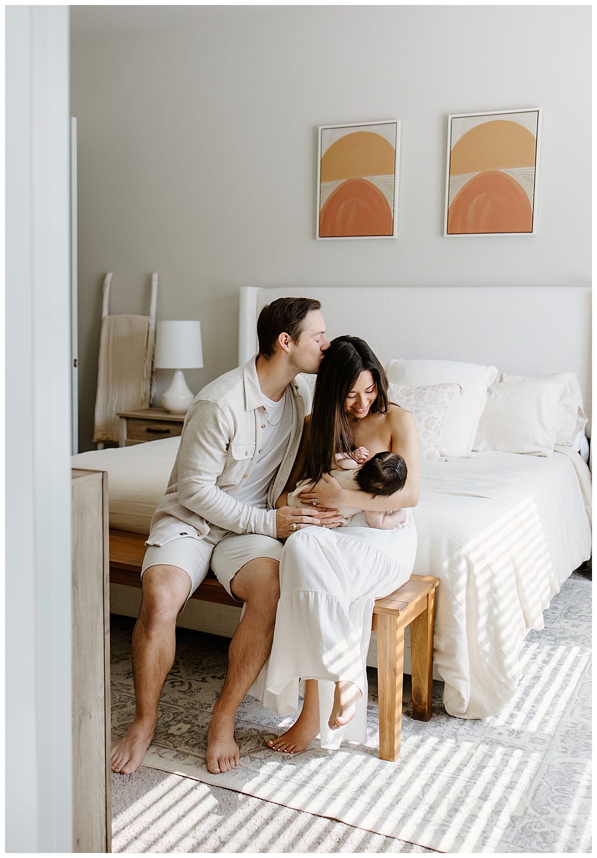 Father kisses wife on the head while she is nursing the baby for Our Adventuring Souls Photography