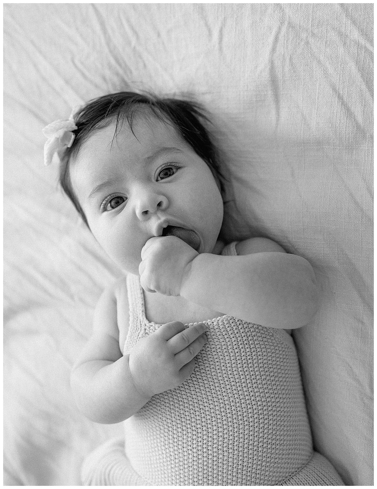 Baby girl pulls hand to her mouth for Our Adventuring Souls Photography