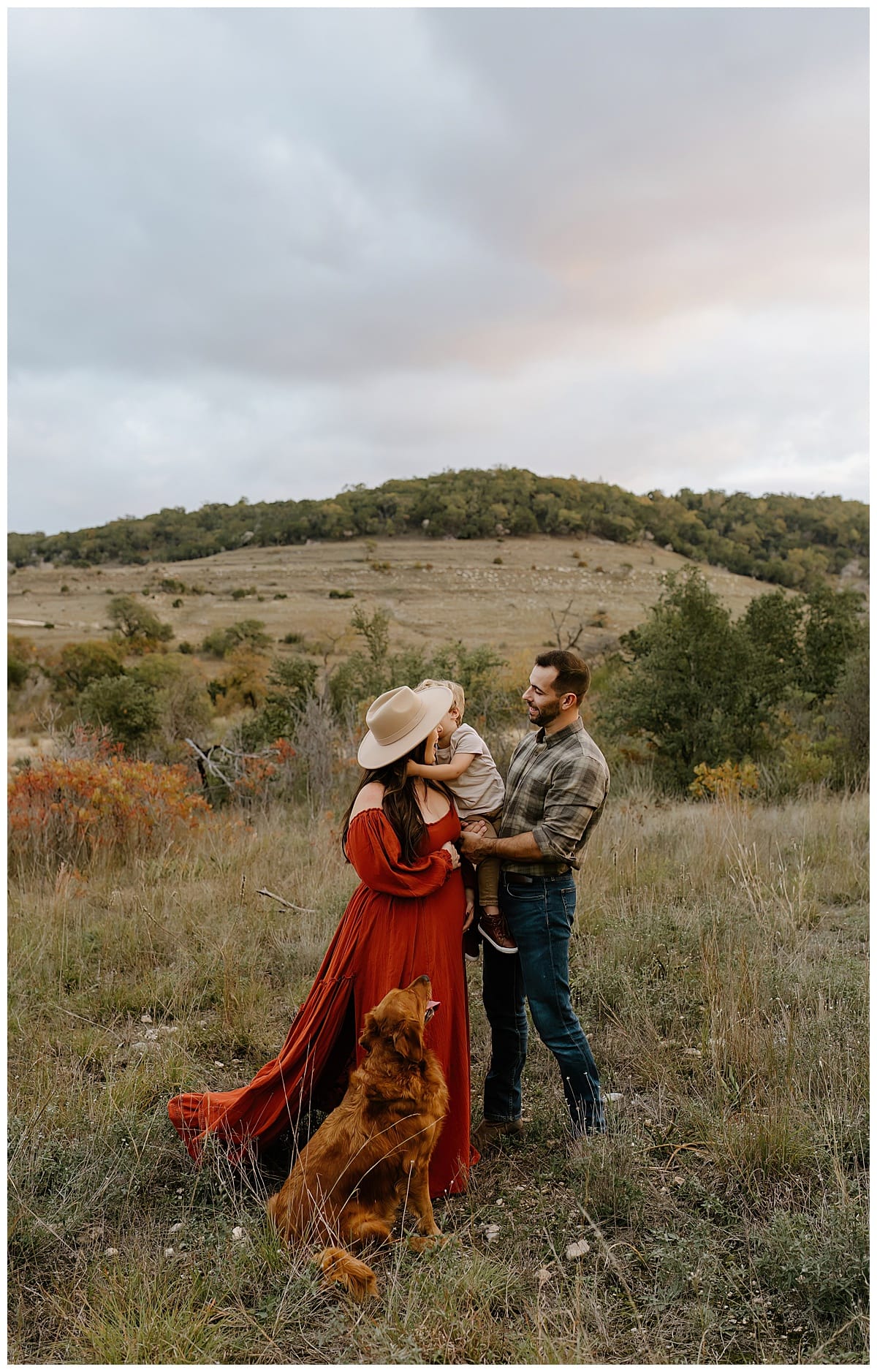 Family smiles together and hold their little one sharing their Baby Announcement
