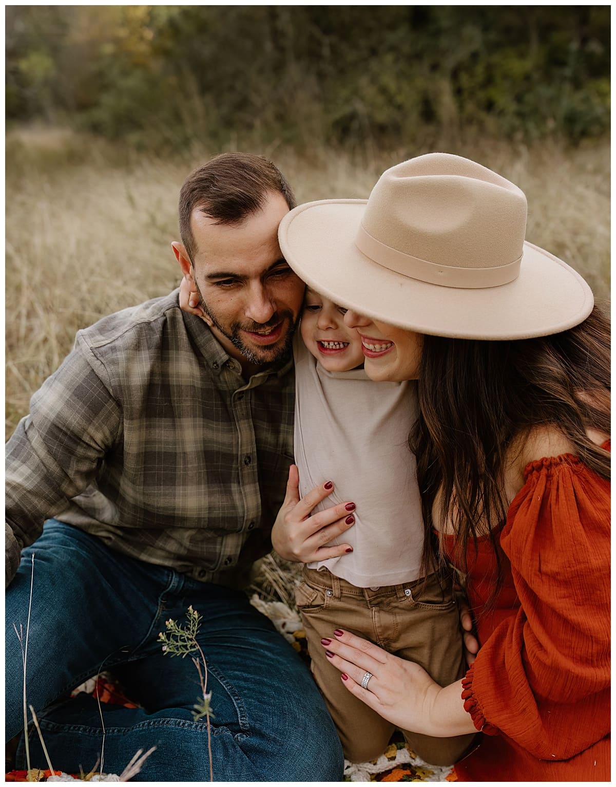 Parents hug their young son after making their Baby Announcement