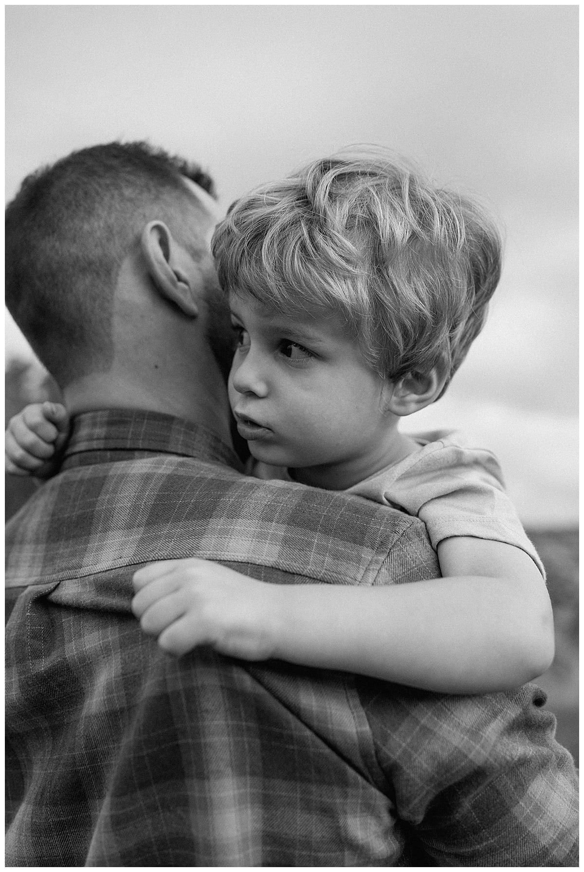 Young son holds dad close for Baby Announcement