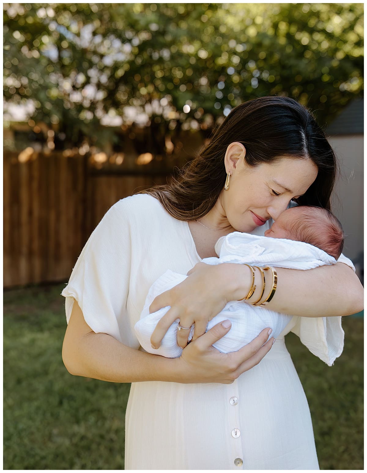 Mom cuddle baby close to Create Memories during their Newborn Storytelling Session