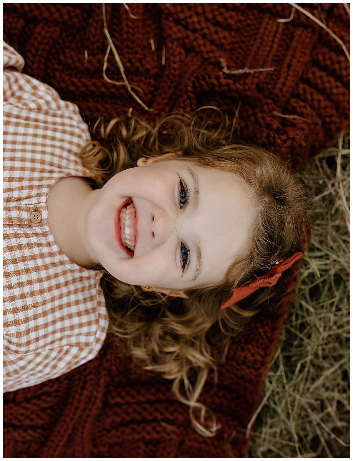 Young girl shares a big smile during their Family Adventure Session