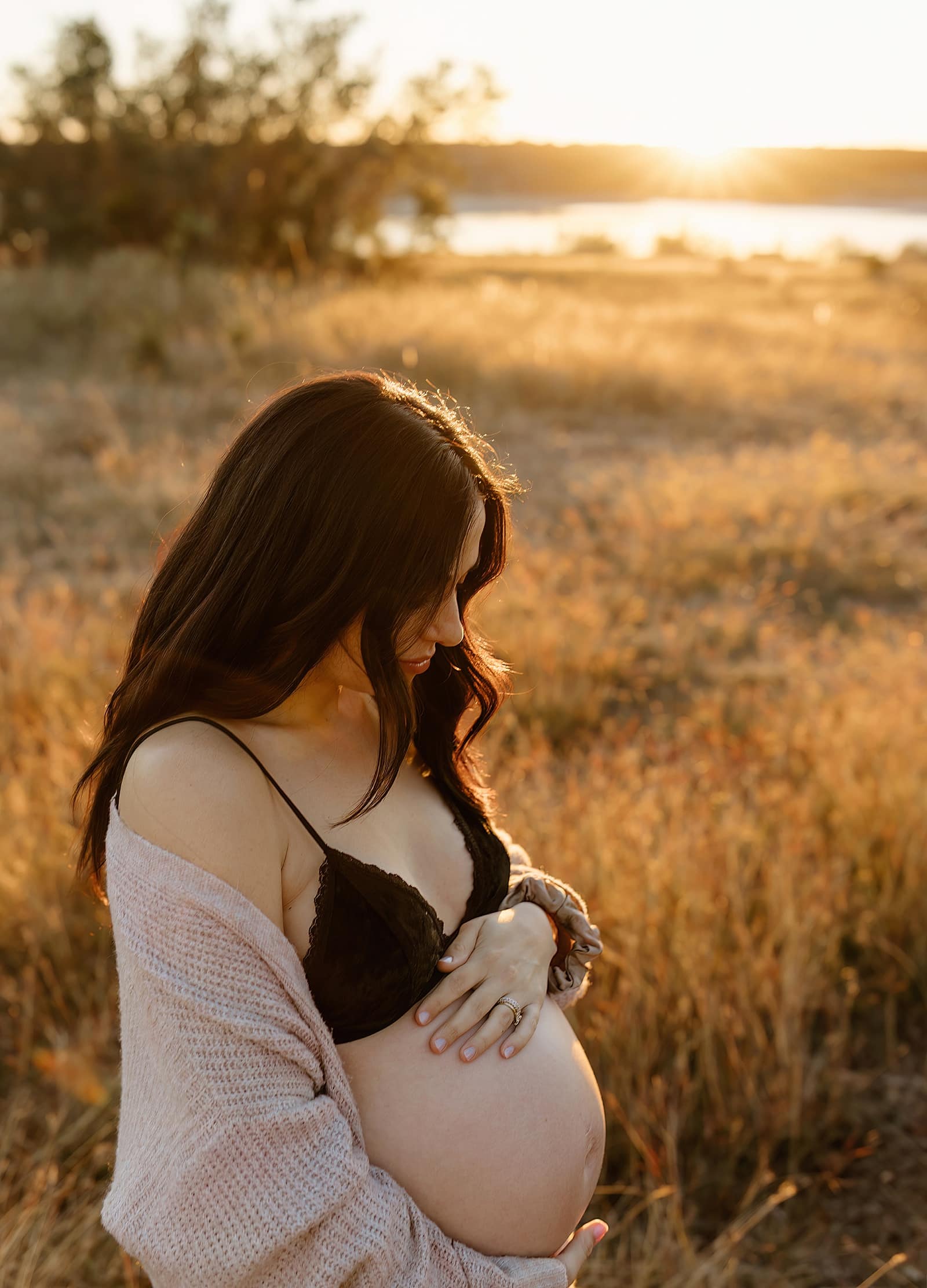 Mother looks down at pregnant belly for Our Adventuring Souls Photography