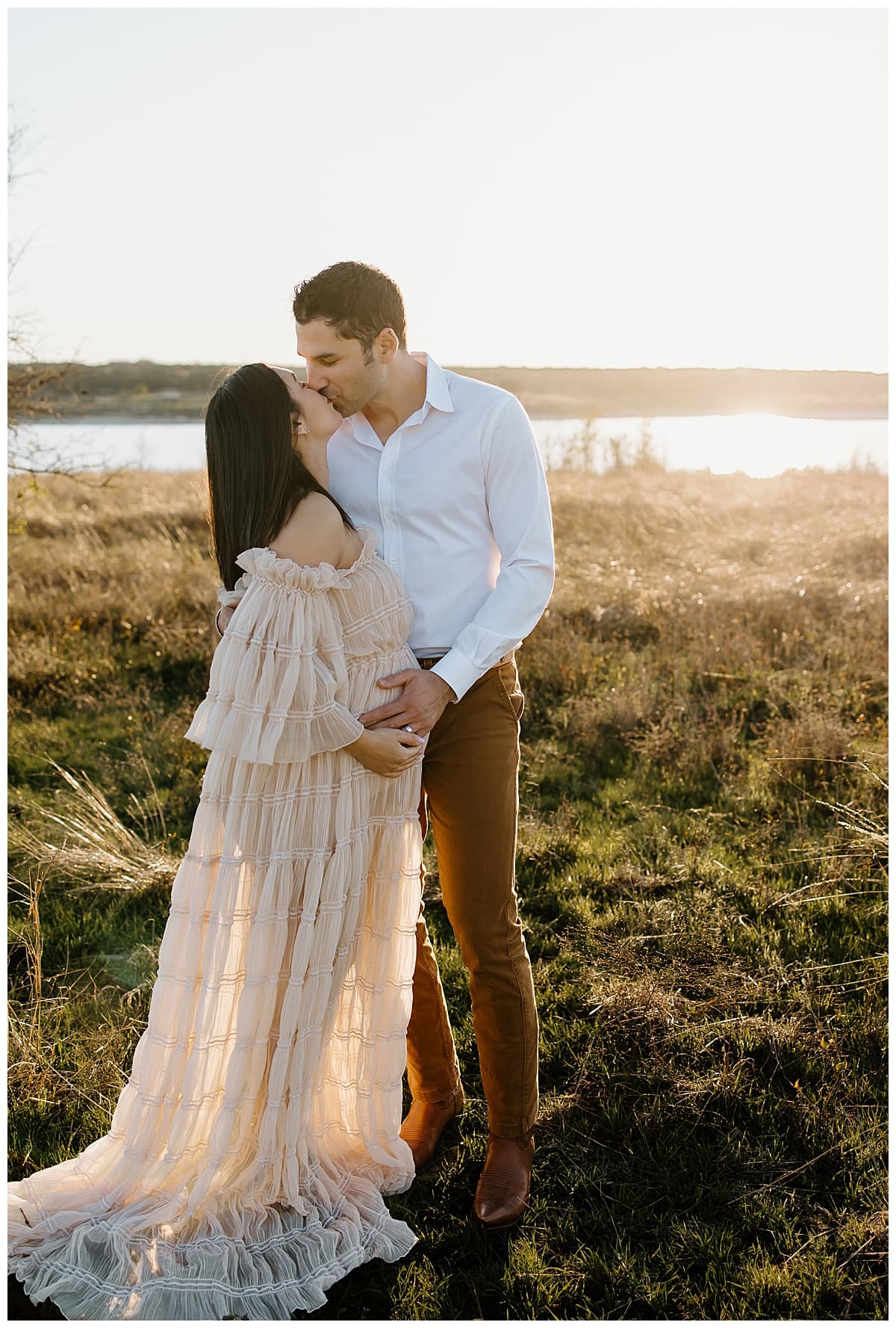 Parents share a kiss during their outdoor lifestyle photoshoot