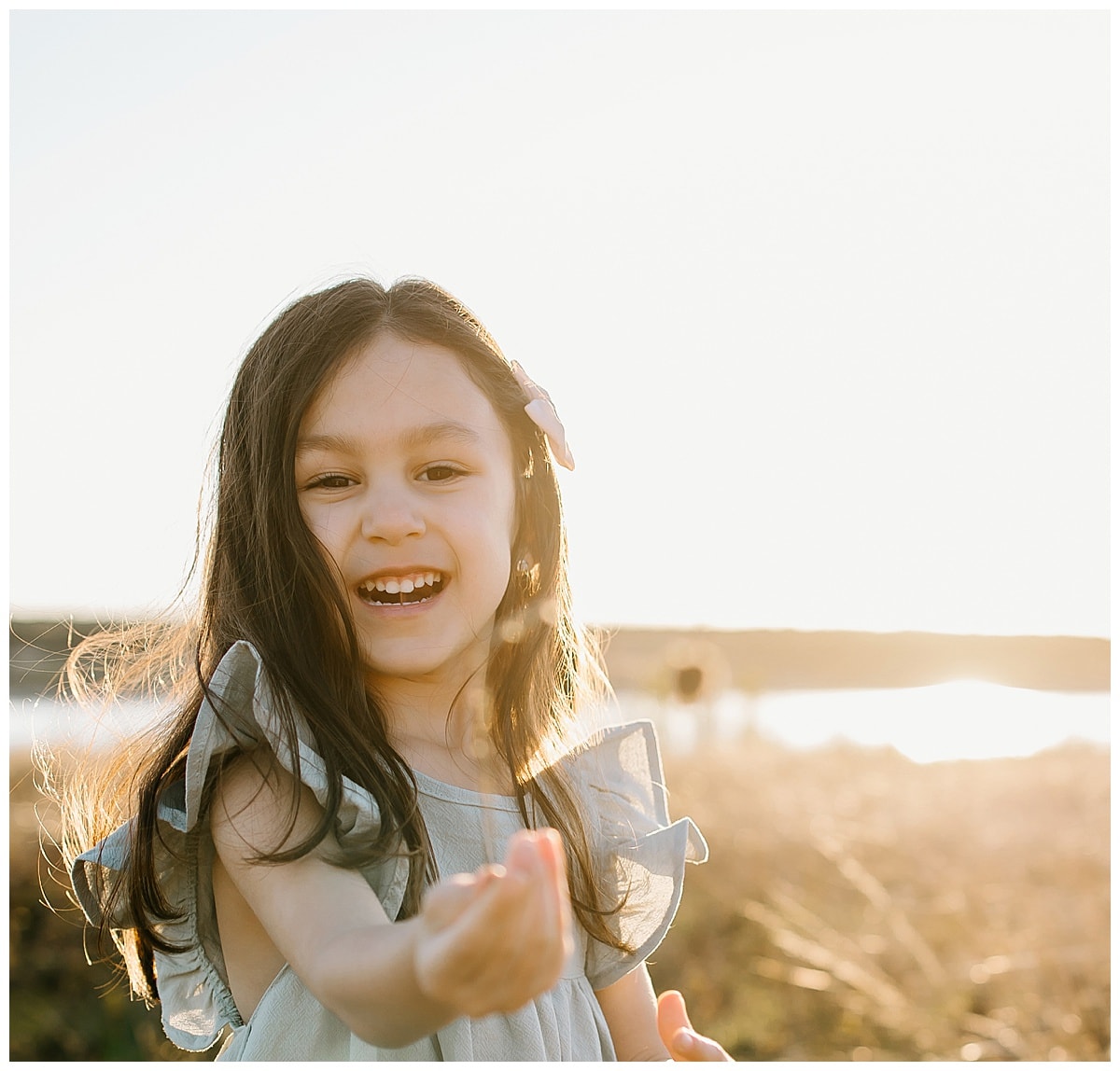 Young girl plays in the grass for Our Adventuring Souls Photography