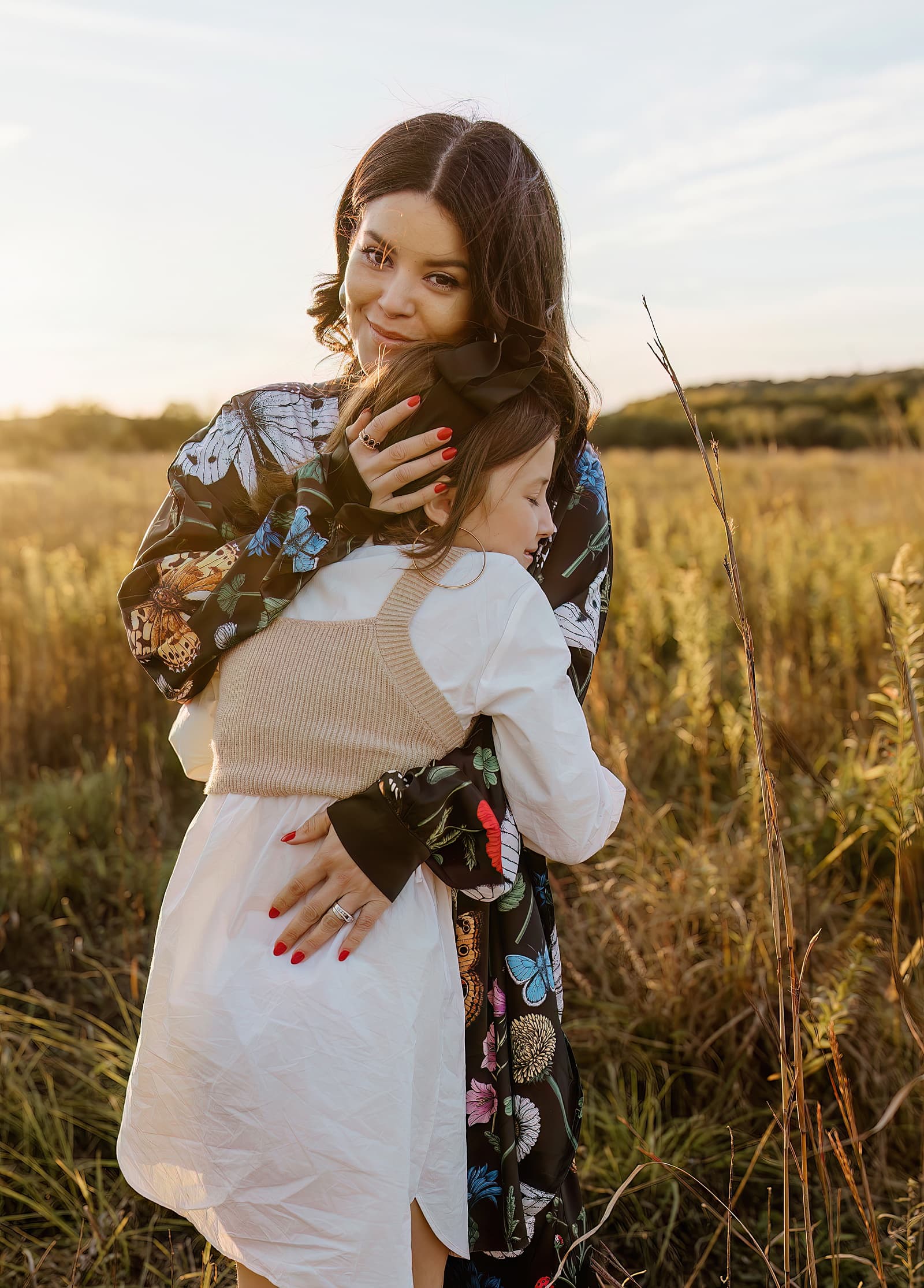Mom and daughter hug each other showing off the best Colorful Family Photo Outfit Inspiration