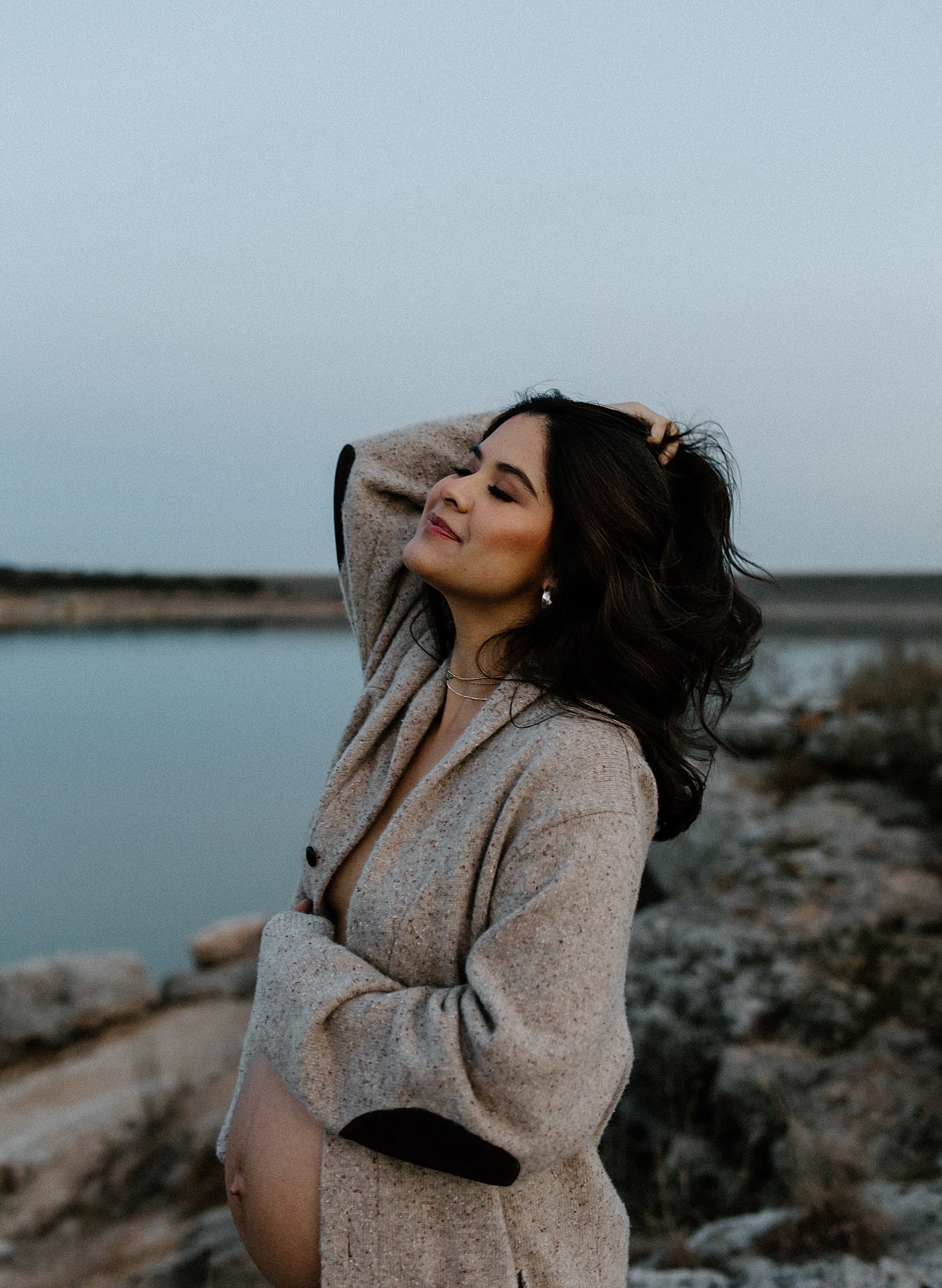 Woman embraces her baby bump for Austin Motherhood Photographer